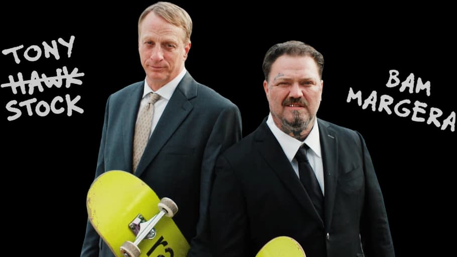 Tony Hawk, or should we say Tony Stock, and Bam Margera in suits holding Ramp skateboards